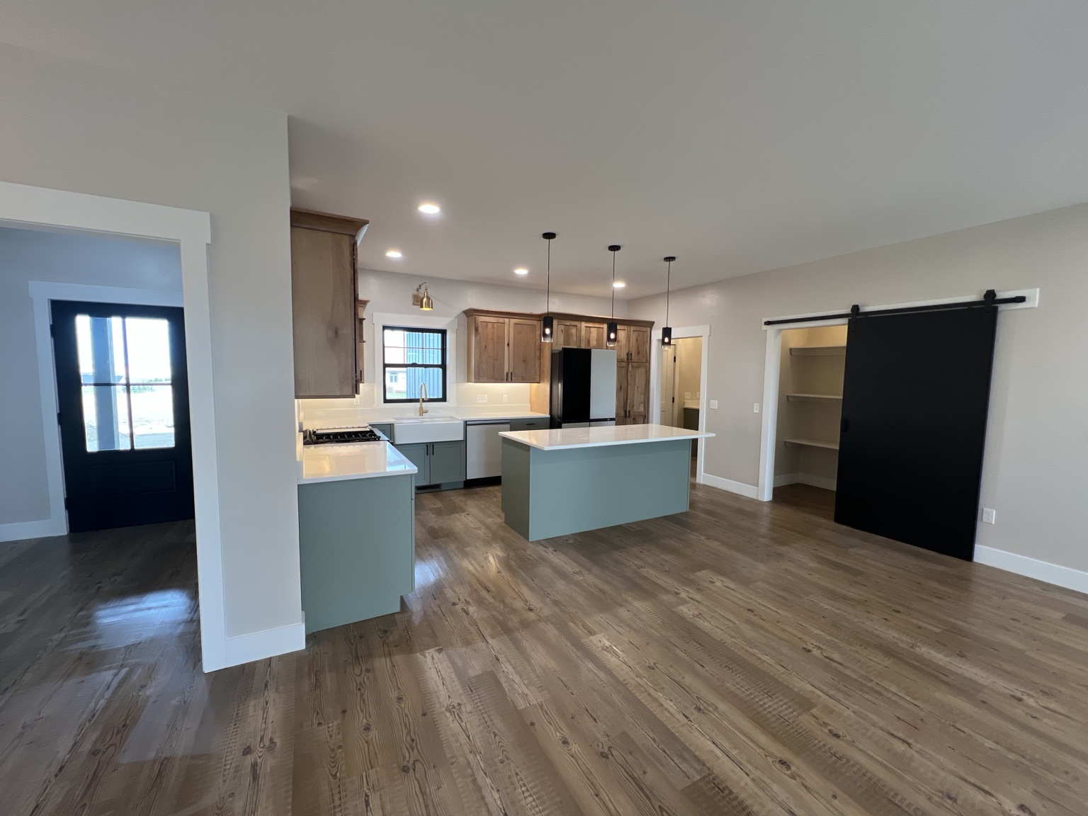 Finished modern custom kitchen with wood cabinetry and central island